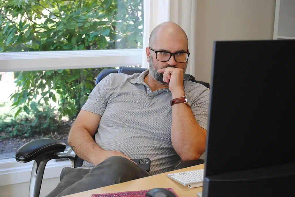 Who Gets My Stuff? The Importance of a Tangible Personal Property List. Man thinking while reading his computer.